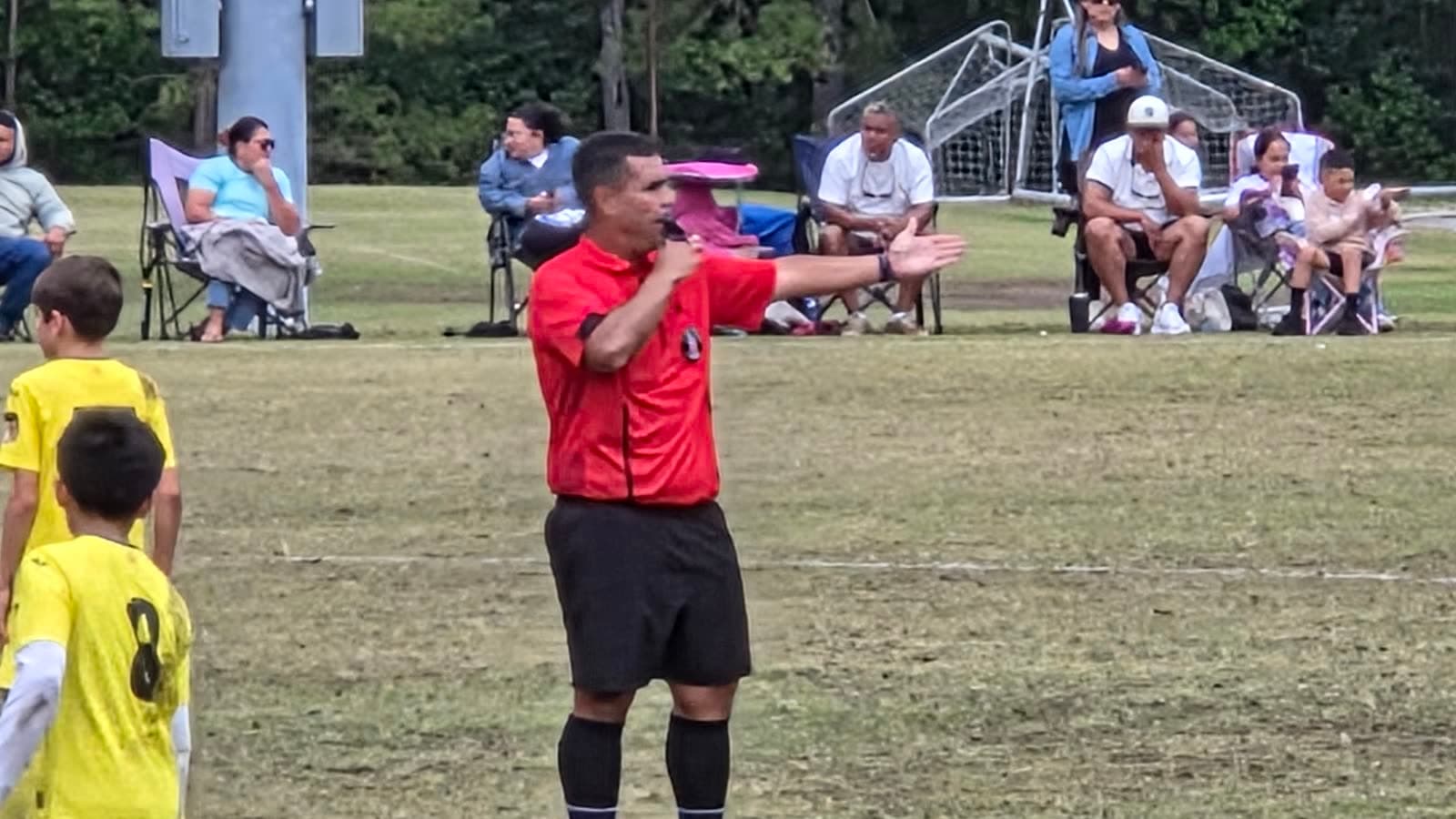Alex refereeing a youth game